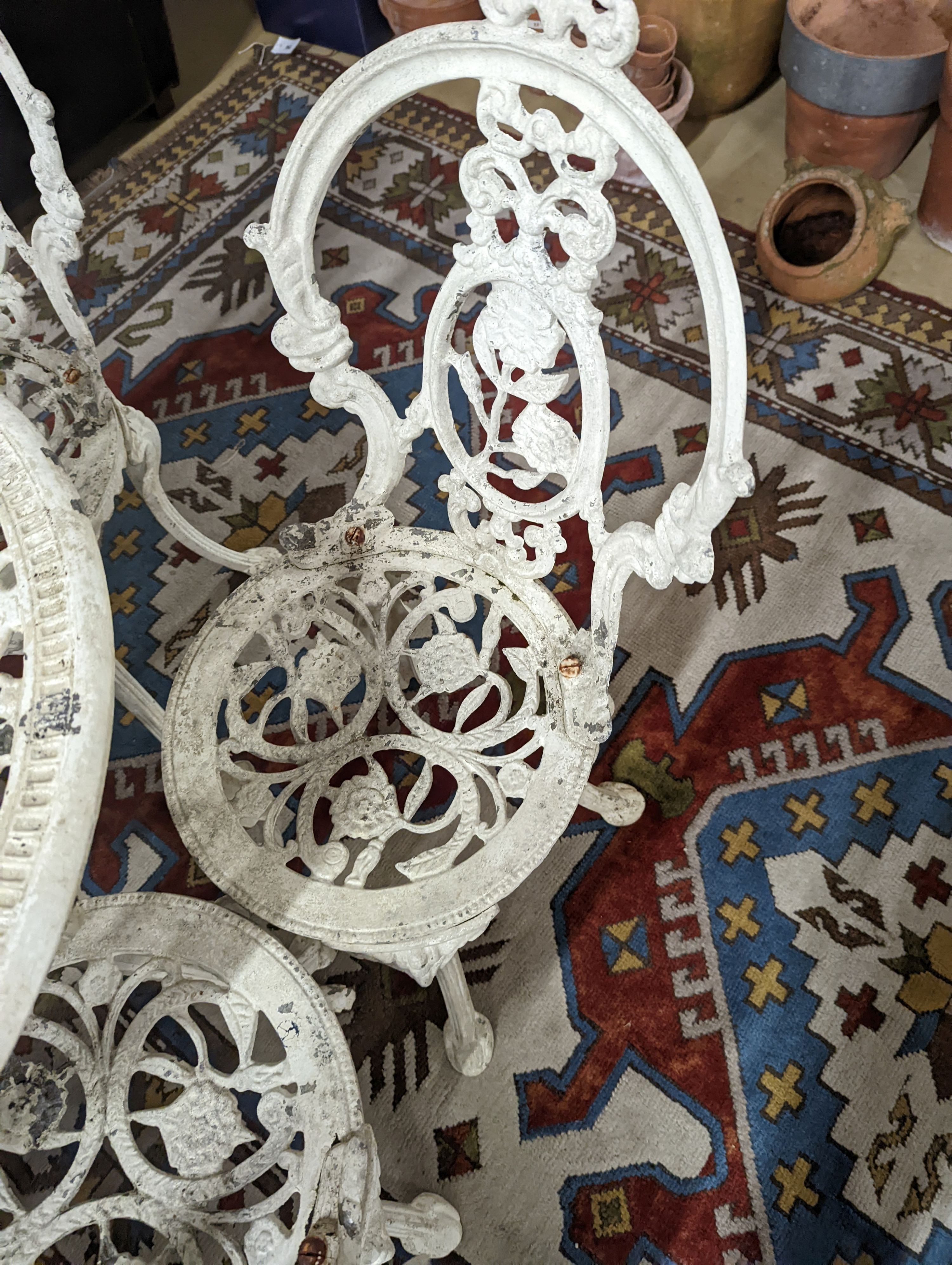 A Victorian style painted aluminium circular garden table, diameter 72cm, together with four chairs